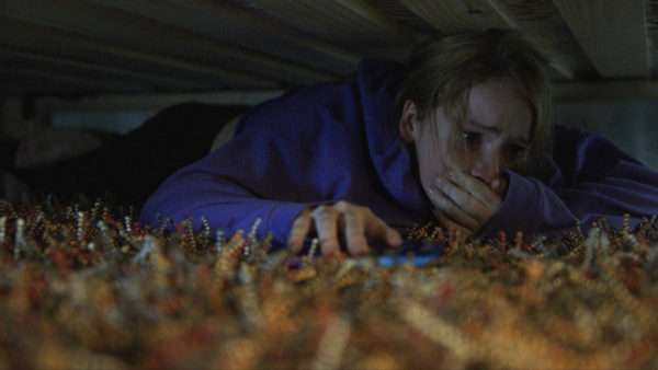 Talitha Eliana Bateman hiding under the bed in Countdown