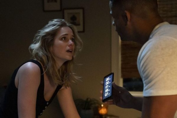 Elizabeth Lail stares at Jordan Calloway holding a phone in Countdown