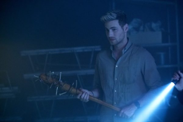 Aaron (Cameron Fuller) holding a bat wrapped in barbed wire