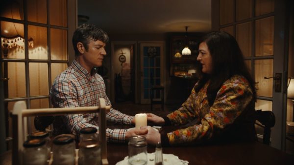 Barry Ward and Maeve Higgins hold hands for a ritual over a candle