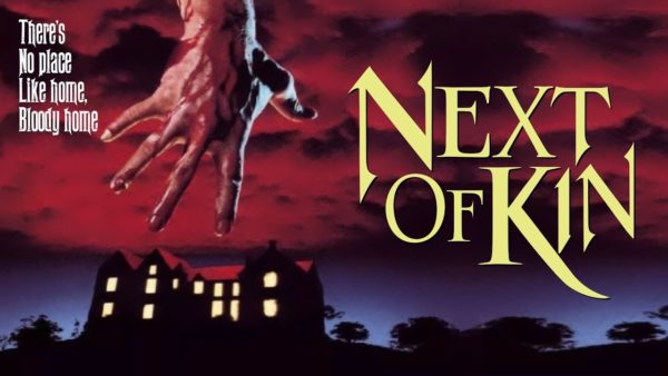 The poster for Next of Kin: a large hand dripping blood reaching down from red clouds towards a mansion with all of the lights on