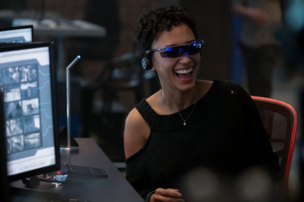 Nora (Andy Allo) laughs while wearing VR goggles