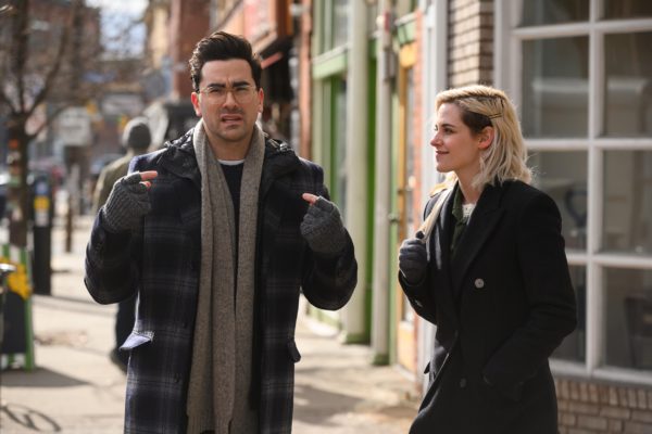 Dan Levy as John stands with Kristen Stewart as Abby on the sidewalk