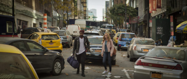 Jovan Adepo as Larry Underwood and Heather Graham as Rita Blakemoor stand in a deserted NY street filled with abandoned cars