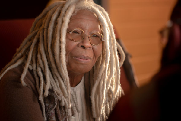 A elderly woman with white dreads