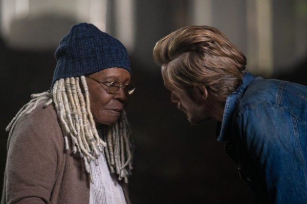 A blonde haired man threatens an older Black woman in glasses and a beanie