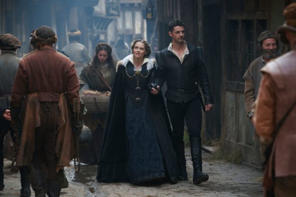 Diana and Matthew walk down the London streets in 1590 clothing