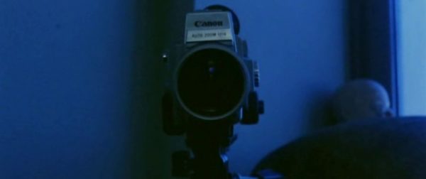 A video camera bathed in blue light