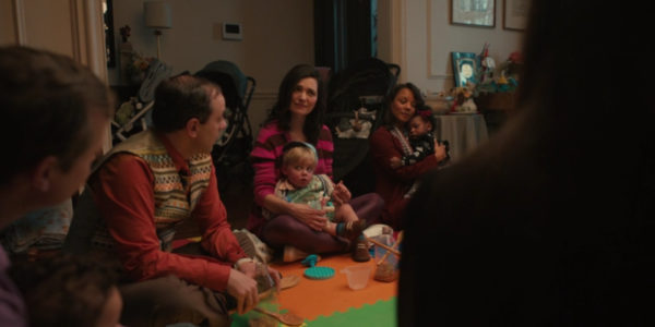 A group of people and children sitting in a circle