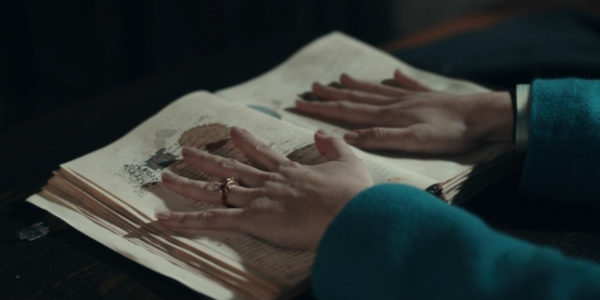 A woman's hands absorbing the text from a book