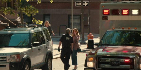 A woman questions an EMT in the street