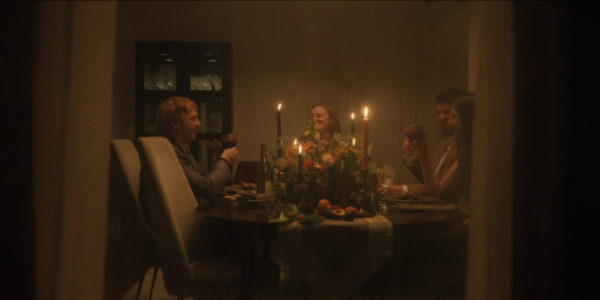 Two men and two woman toast at a fancy dinner