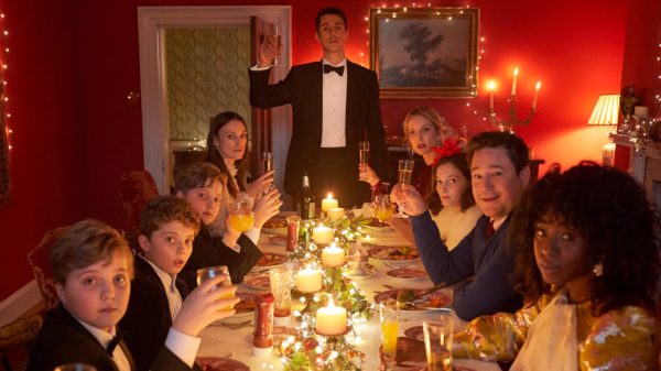 A candlelit table of guests toast