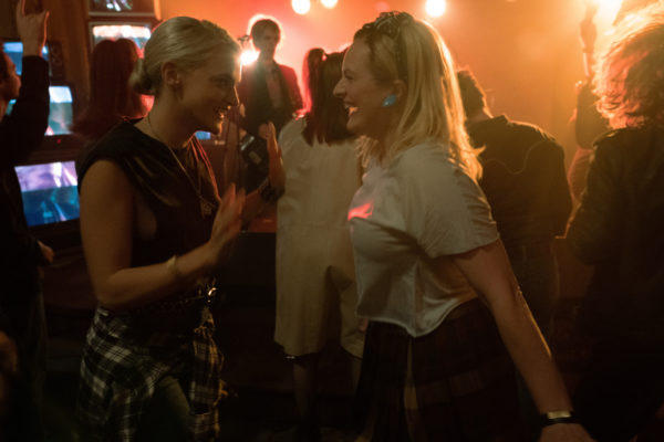 Two blonde women dancing in a club