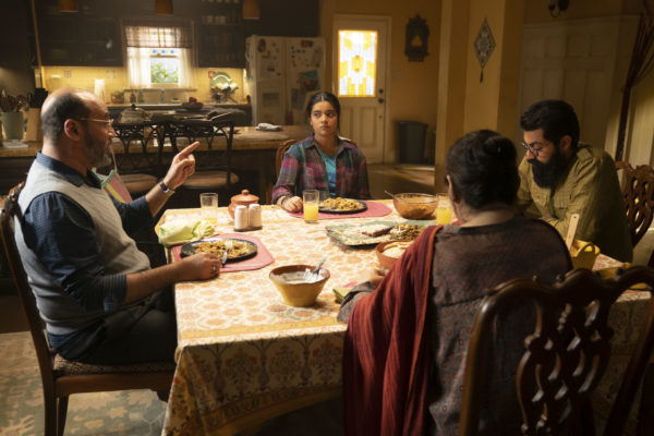 An Indian family sits at the dining table