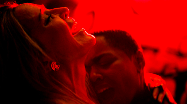 Two women having sex in red light
