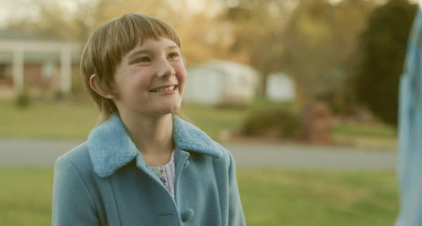 A young girl in the 70s in a blue coat