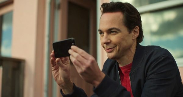 Jim Parsons smiles slightly as he takes a picture