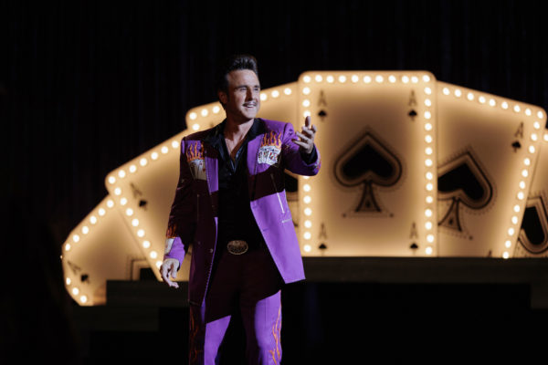 David Arquette as a magician wearing a purple suit