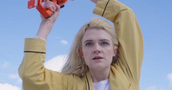 A blonde woman in a yellow shirt