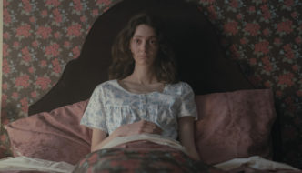 A woman sits upright in bed